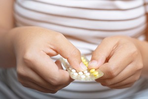 A woman taking birth control pills as a contraceptive method