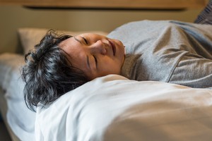 Asian woman 40s plump body take a nap or sleep on a white bed in bedroom for rest and relax because fatigue or tired Birth control pill and cancer risk - myth or fact?