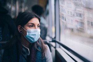 Post hookup anxiety Young woman wearing protective face mask, she sitting in bus transportation in the city